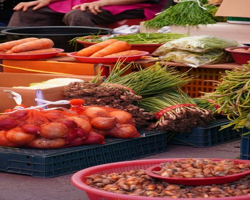 Various fresh vegetables displayed clearly at a local outdoor market