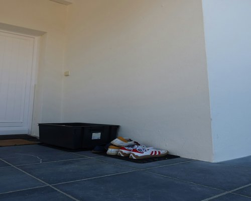 A neat entryway with a dedicated shoe rack holding casual footwear